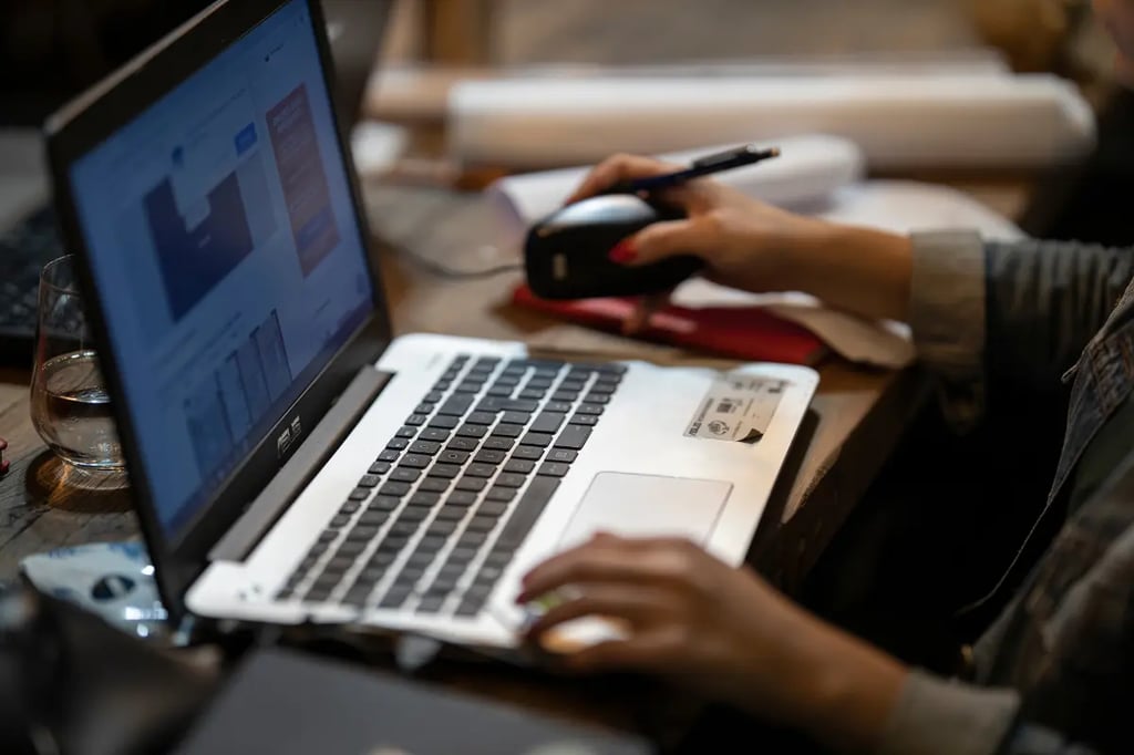Close-up of hands navigating a laptop, exploring online homeschool options for personalized learning