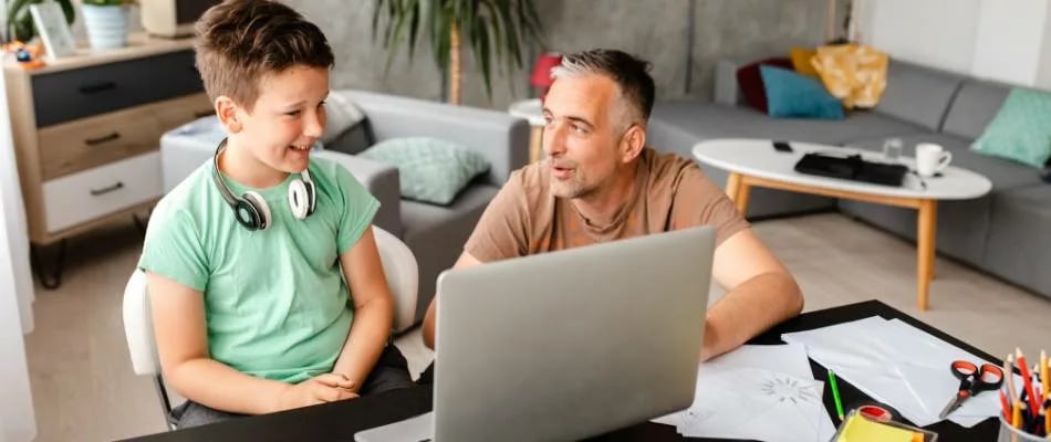 Why homeschooling is the best choice shown by a happy parent and child learning together at home with a laptop and schoolwork.