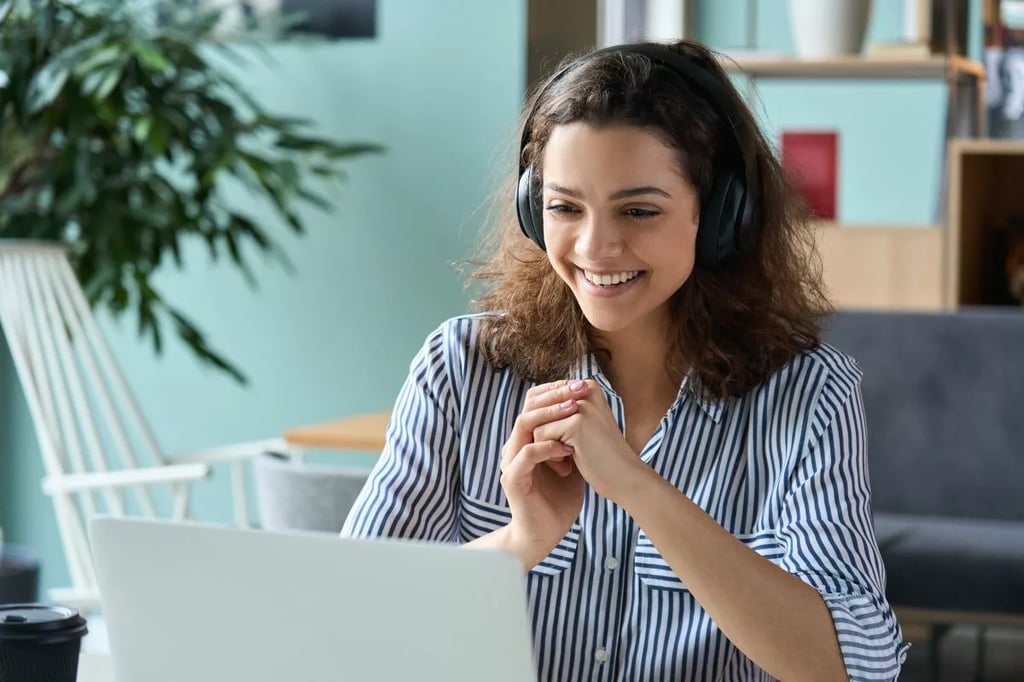 Private online high school represented by a smiling student wearing headphones and engaging in a virtual lesson on a laptop.