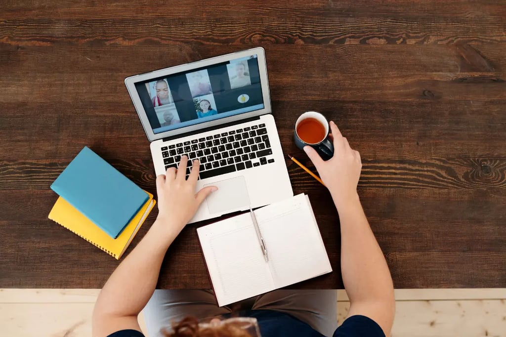 Digital classroom setup with a student participating in a group video call while studying and drinking coffee.